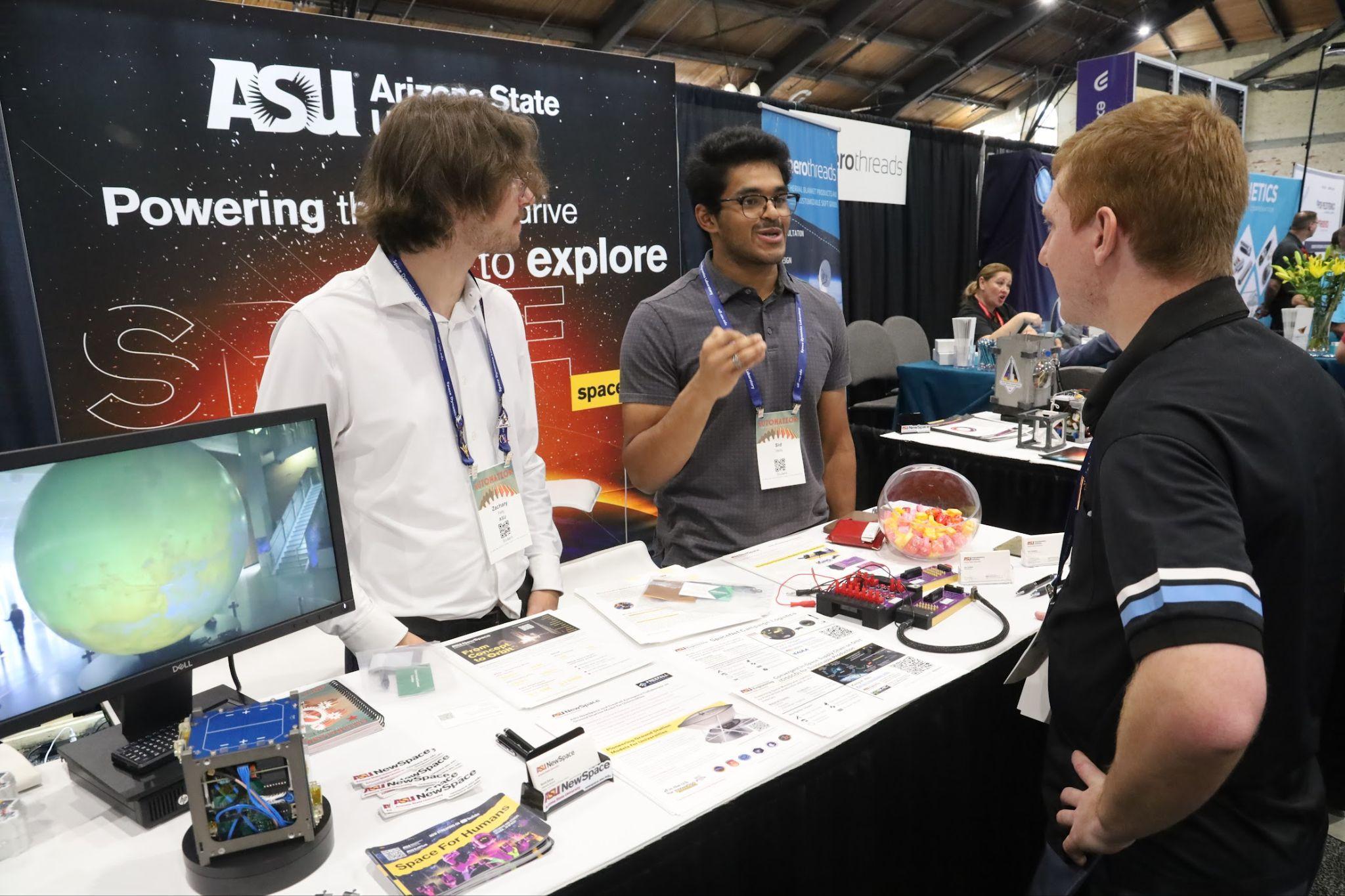 Sid Vaidyanathan at an ASU NewSpace booth talking to participants.